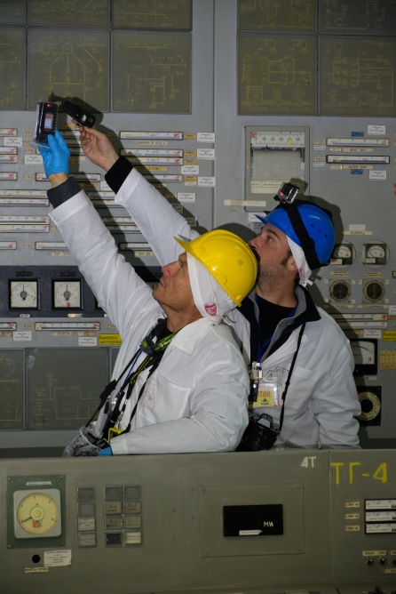 Two visitors investigate the notable radiation hot spot in the Unit 2 control room.