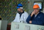 A visitor and a career turbine engineer share a smoke in the Unit 2 control room at Chernobyl